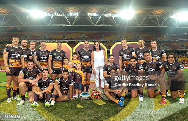 Corey Parker of the Broncos poses for a photo with team mates to celebrate his 300th NRL match after the round one NRL match between the Brisbane...