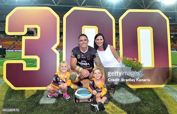 Corey Parker of the Broncos poses for a photo with his wife and two children to celebrate his 300th NRL match after the round one NRL match between...