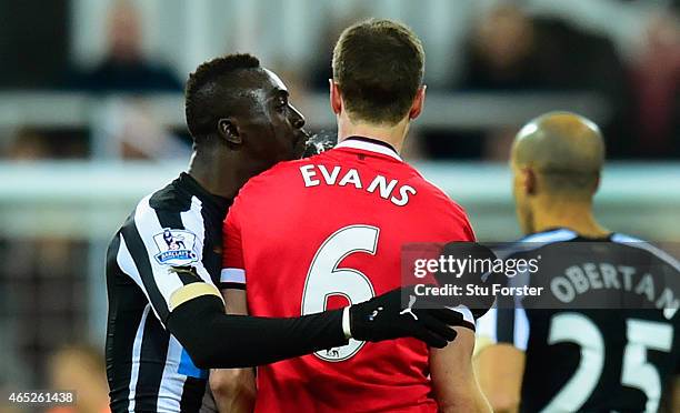 Manchester United player Jonny Evans looks on as Papiss Cisse of Newcastle appears to spit during the Barclays Premier League match between Newcastle...