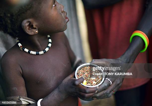 Children gather grain off a field demarcated for food-drops at a village in Nyal, an administrative hub of Panyijar county in Unity state, south...