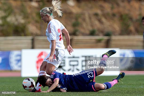 Asano Nagasato of Japan challenges Pernille M. Harder of Denmark during the Women's Algarve Cup match between Japan and Denmark on March 4, 2015 in...