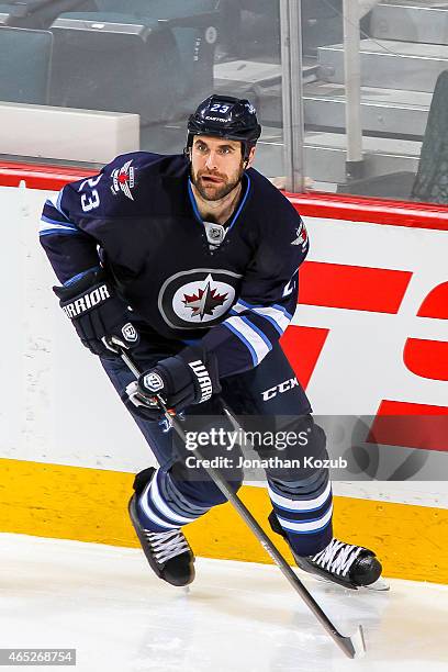 Jay Harrison of the Winnipeg Jets keeps an eye on the play during third period action against the St. Louis Blues on February 26, 2015 at the MTS...