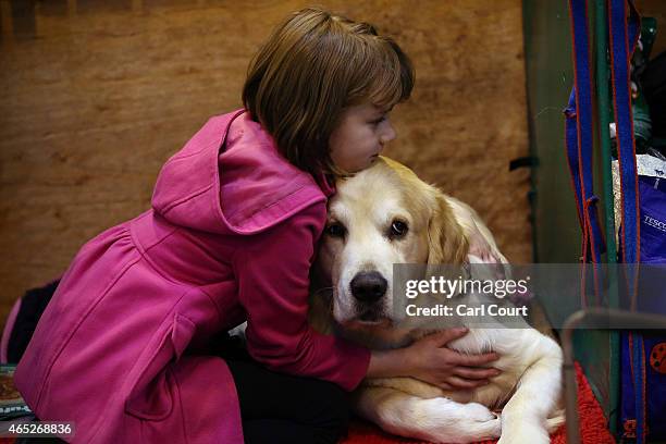 Girl hugs her dog on the first day of Crufts dog show at the National Exhibition Centre on March 5, 2015 in Birmingham, England. First held in 1891,...