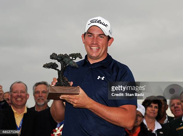 Scott Stallings poses with the trophy after winning the Farmers Insurance Open at Torrey Pines Golf Course on January 26, 2014 in La Jolla,...