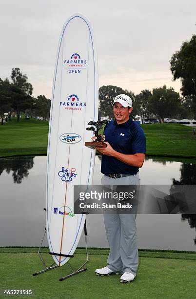 Scott Stallings poses with the trophy and a surfboard after winning the Farmers Insurance Open at Torrey Pines Golf Course on January 26, 2014 in La...