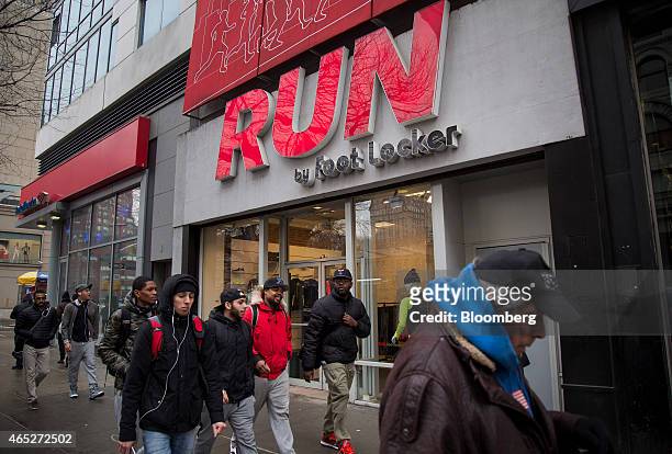 Pedestrians walk past a Foot Locker Inc. Run store in New York, U.S., on Wednesday, March 4, 2015. Foot Locker Inc. Is scheduled to release earnings...