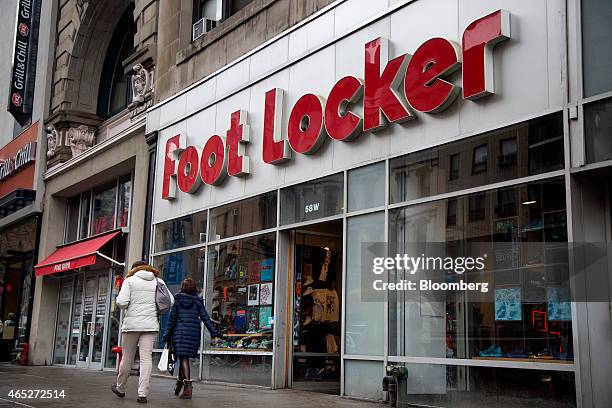 Pedestrians walk past a Foot Locker Inc. Store in New York, U.S., on Wednesday, March 4, 2015. Foot Locker Inc. Is scheduled to release earnings...