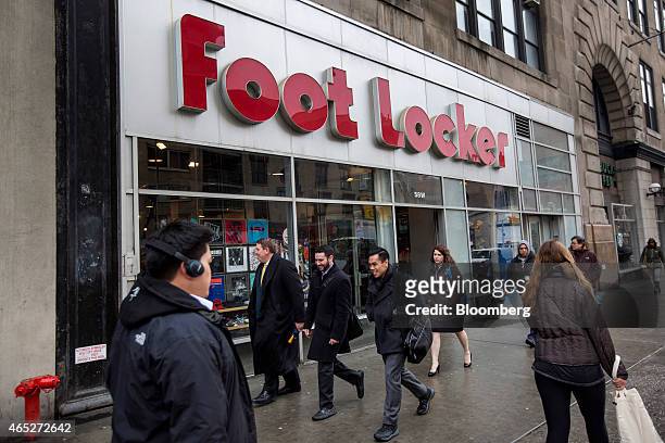 Pedestrians walk past a Foot Locker Inc. Store in New York, U.S., on Wednesday, March 4, 2015. Foot Locker Inc. Is scheduled to release earnings...