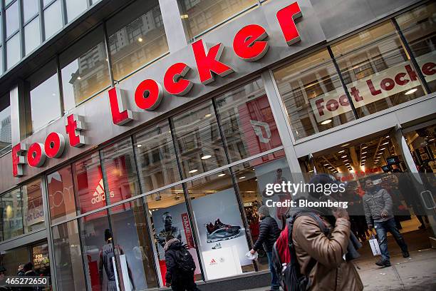 Pedestrians walk past a Foot Locker Inc. Store in New York, U.S., on Wednesday, March 4, 2015. Foot Locker Inc. Is scheduled to release earnings...