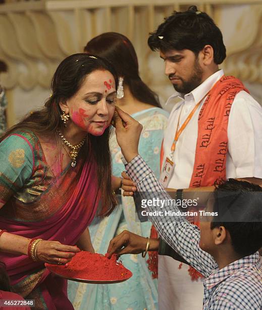 Bollywood actress and BJP MP from Mathura, Hema Malini takes part in the Holi celebration programme at CGA ground near Karkardooma Court on March 5,...