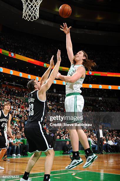 Kelly Olynyk of the Boston Celtics shoots against Mirza Teletovic of the Brooklyn Nets on January 26, 2014 at the TD Garden in Boston, Massachusetts....