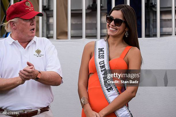 Donald Trump applauds Miss Universe Paulina Vega of Colombia during the Military Appreciation Ceremony prior to the start of the first round of the...