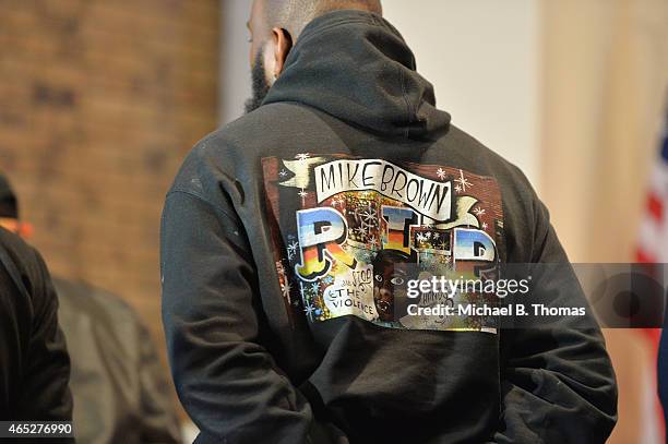 Michael Brown Sr., father of slain teenager Michael Brown Jr., wears a sweatshirt depicting his son during a press conference at the Greater St. Mark...