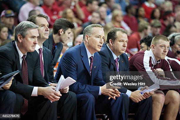 Head Coach Billy Kennedy of the Texas A&M Aggies on the bench with his assistant coaches during a game against the Arkansas Razorbacks at Bud Walton...