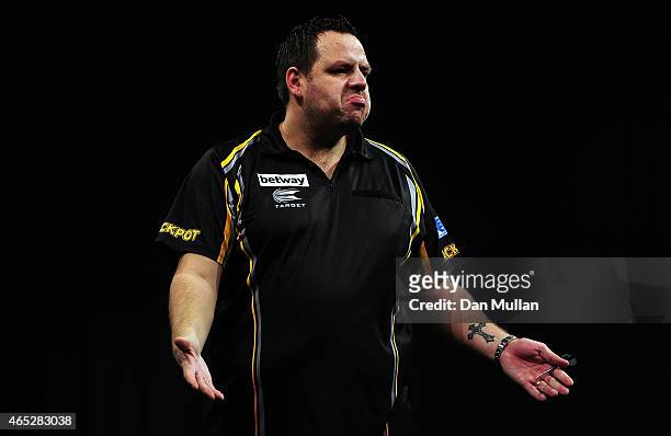 Adrian Lewis of England celebrates after winning a leg against Stephen Bunting of England during The Betway Premier League Darts at Westpoint Arena...