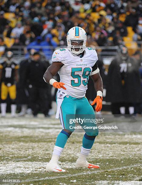 Linebacker Dannell Ellerbe of the Miami Dolphins looks on from the field during a game against the Pittsburgh Steelers at Heinz Field on December 8,...