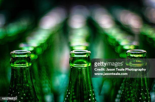 green bottles in rows - glas bottle stock pictures, royalty-free photos & images