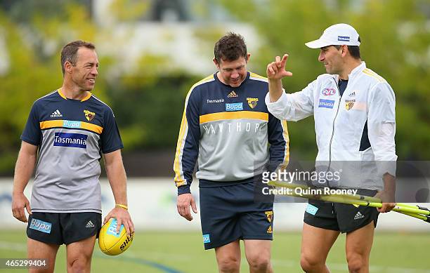 Head coach Alastair Clarkson of the Hawks talks to assistant coaches Brett Ratten and Adem Yze during a Hawthorn Hawks AFL training session at...