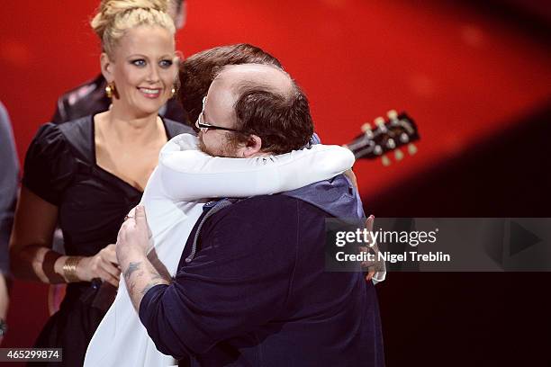 Singer Ann Sophie and singer Andreas Kuemmert react during the finals of the TV show 'Our Star For Austria' on March 5, 2015 in Hanover, Germany....