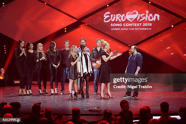 Singer Andreas Kuemmert, singer Ann Sophie and host Barbara Schoeneberger react during the finals of the TV show 'Our Star For Austria' on March 5,...