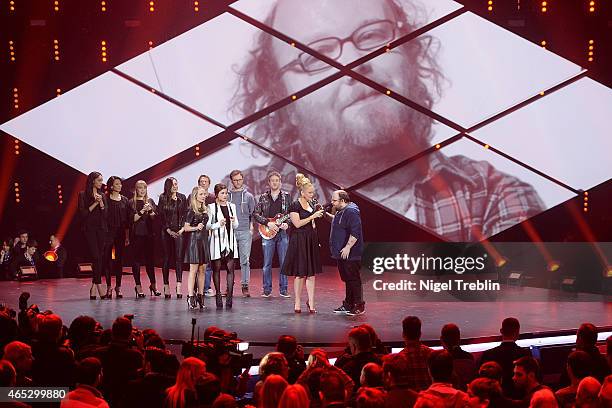 Singer Andreas Kuemmert, singer Ann Sophie and host Barbara Schoeneberger react during the finals of the TV show 'Our Star For Austria' on March 5,...