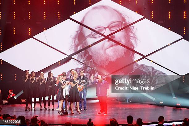 Singer Andreas Kuemmert, singer Ann Sophie and host Barbara Schoeneberger react during the finals of the TV show 'Our Star For Austria' on March 5,...