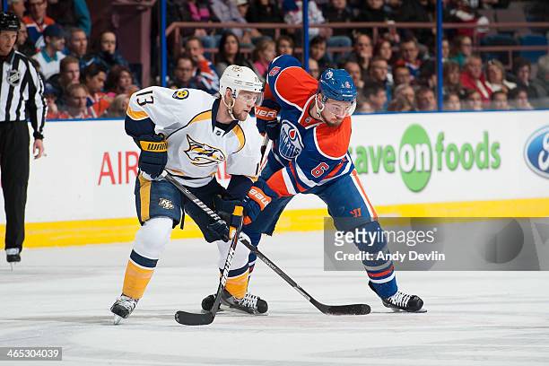 Jesse Joensuu of the Edmonton Oilers lines up for a face off against Nick Spaling of the Nashville Predators on January 26, 2014 at Rexall Place in...