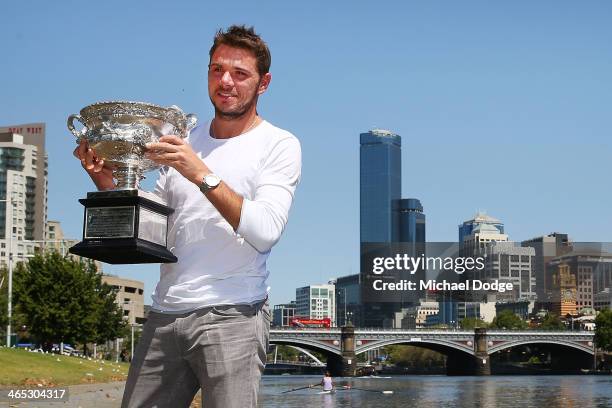 Stanislas Wawrinka of Switzerland poses with the Norman Brookes Challenge Cup at Melbourne University Boat Club, after winning the 2014 Australian...