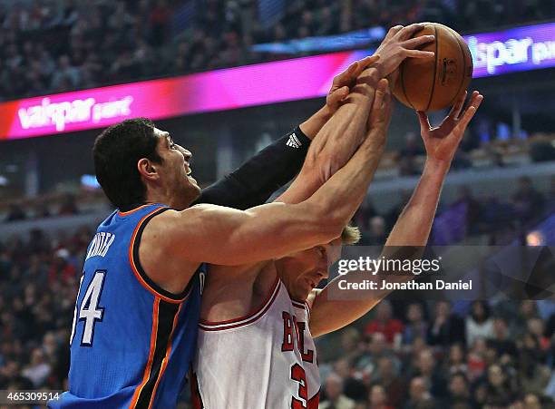 Enes Kanter of the Oklahoma City Thunder battles for a rebound with Mike Dunleavy of the Chicago Bulls at the United Center on March 5, 2015 in...
