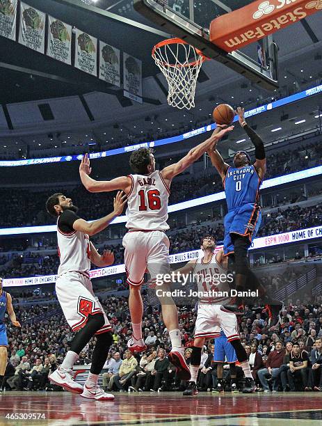 Russell Westbrook of the Oklahoma City Thunder goes up for a shot over Nikola Mirotic, Pau Gasol and Kirk Hinrich of the Chicago Bulls at the United...