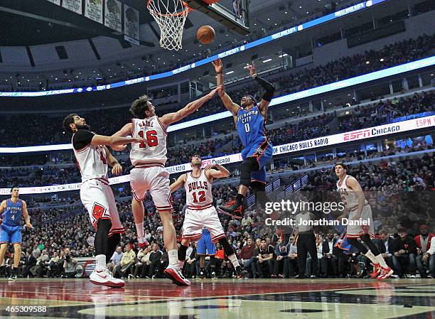 Russell Westbrook of the Oklahoma City Thunder goes up for a shot over Nikola Mirotic, Pau Gasol and Kirk Hinrich of the Chicago Bulls at the United...