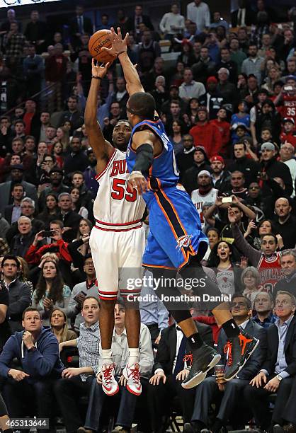 Twaun Moore of the Chicago Bulls shoots the game-winning three point shot against Russell Westbrook of the Oklahoma City Thunder at the United Center...