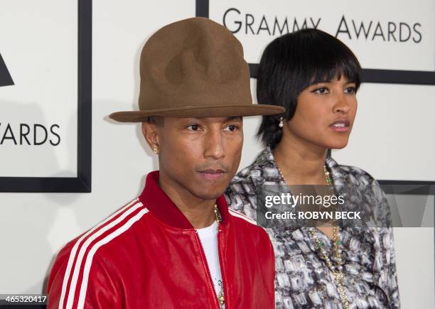 Recording artist Pharrell Williams and Helen Lasichanh arrive on the red carpet for the 56th Grammy Awards at the Staples Center in Los Angeles on...