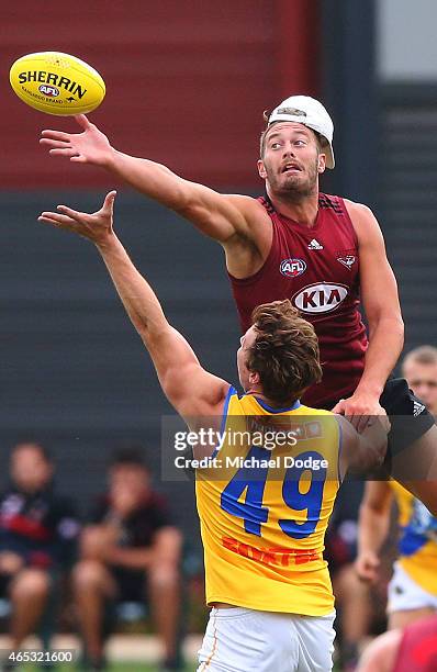 Tom Bellchambers of the Bombers taps the ball over Ayce Cordy of Williamstown during an Essendon Bombers match simulation training session against...