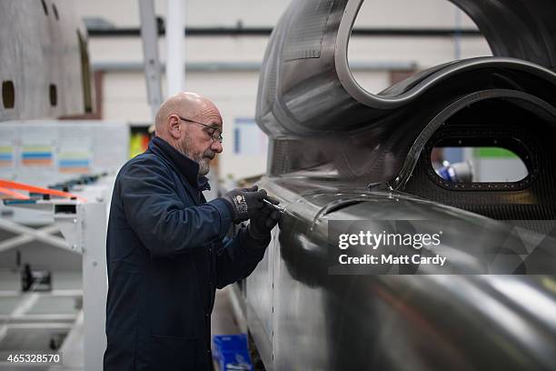 Engineer works on a carbon-fibre body panel of the Bloodhound SSC vehicle currently taking shape at its design centre in Avonmouth on March 5, 2015...