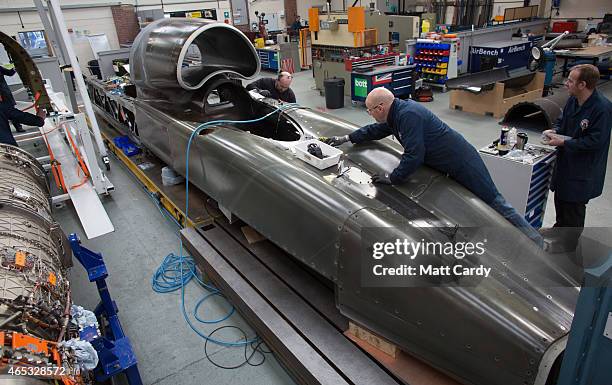 Engineers work on the carbon-fibre body of the Bloodhound SSC vehicle currently taking shape at its design centre in Avonmouth on March 5, 2015 in...