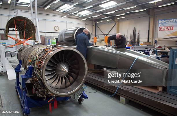 Engineers work on the carbon-fibre body of the Bloodhound SSC vehicle currently taking shape at its design centre in Avonmouth on March 5, 2015 in...