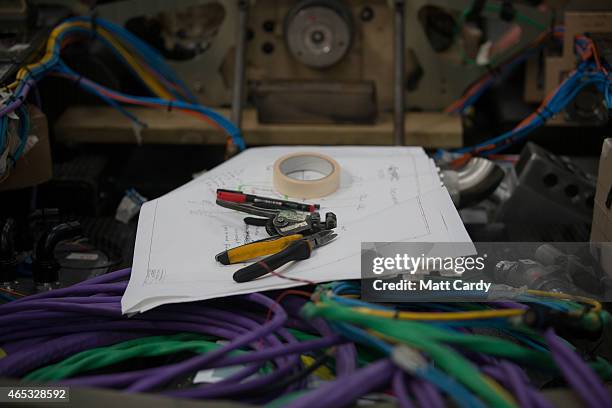 Engineers work on the wiring loom in the rear end of the Bloodhound SSC vehicle currently taking shape at its design centre in Avonmouth on March 5,...