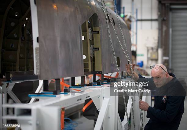 Engineers work on a body panel of the Bloodhound SSC vehicle currently taking shape at its design centre in Avonmouth on March 5, 2015 in Bristol,...