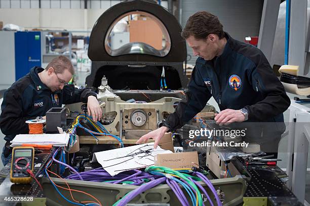 Engineers work on the wiring loom in the rear end of the Bloodhound SSC vehicle currently taking shape at its design centre in Avonmouth on March 5,...