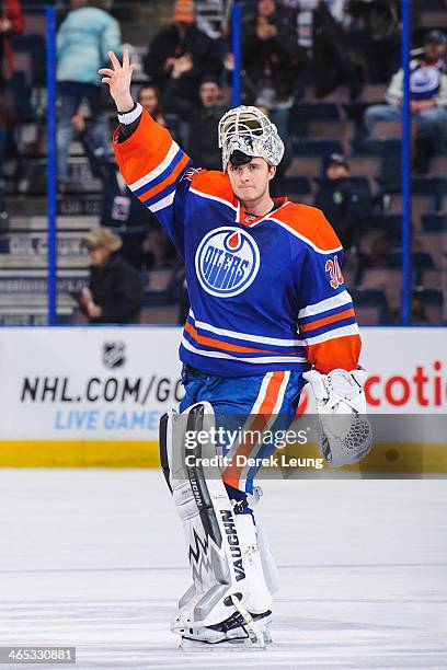 Ben Scrivens of the Edmonton Oilers waves to the crowd after earning the first of three stars after defeating the Nashville Predators during an NHL...