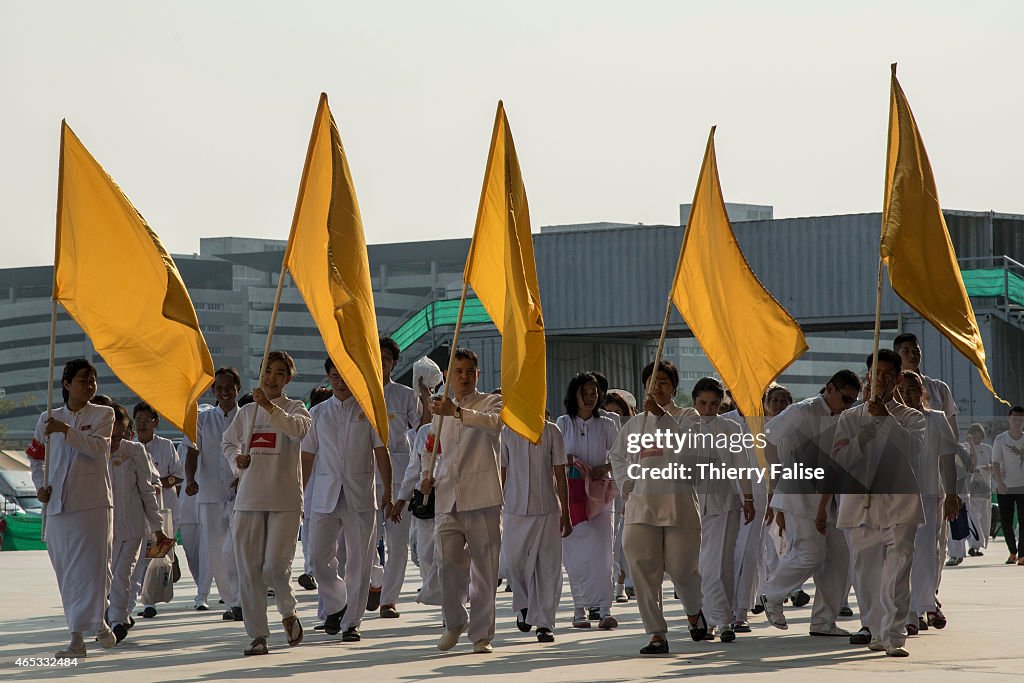 A group of Dhammakaya temple's members carrying flags arrive...