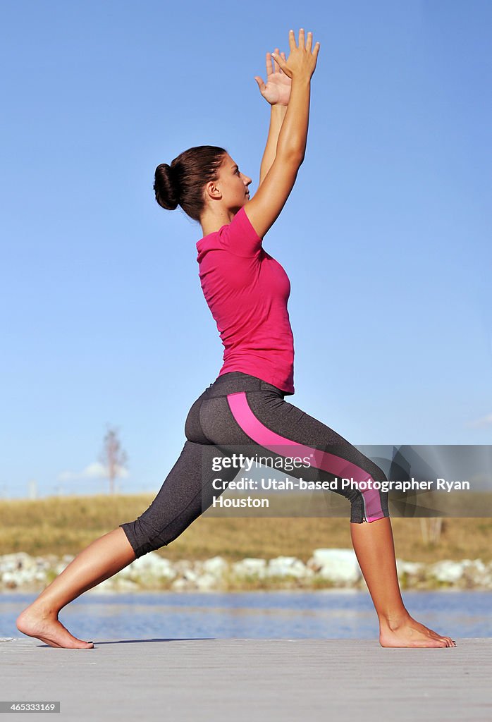 Fit Female Does Yoga Near a Lake