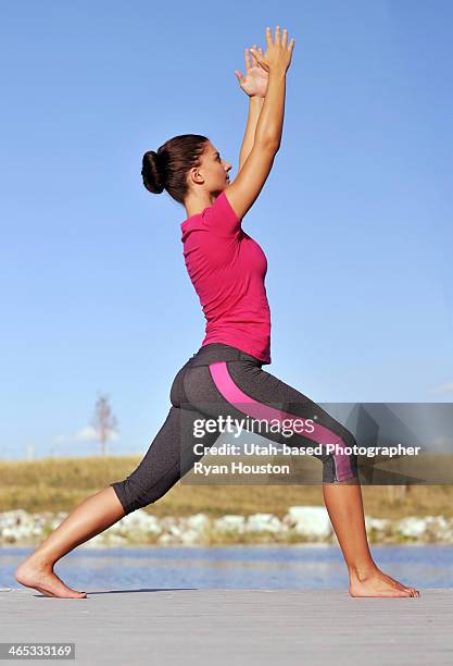Fit Female Does Yoga Near A Lake, Bildbanksbilder