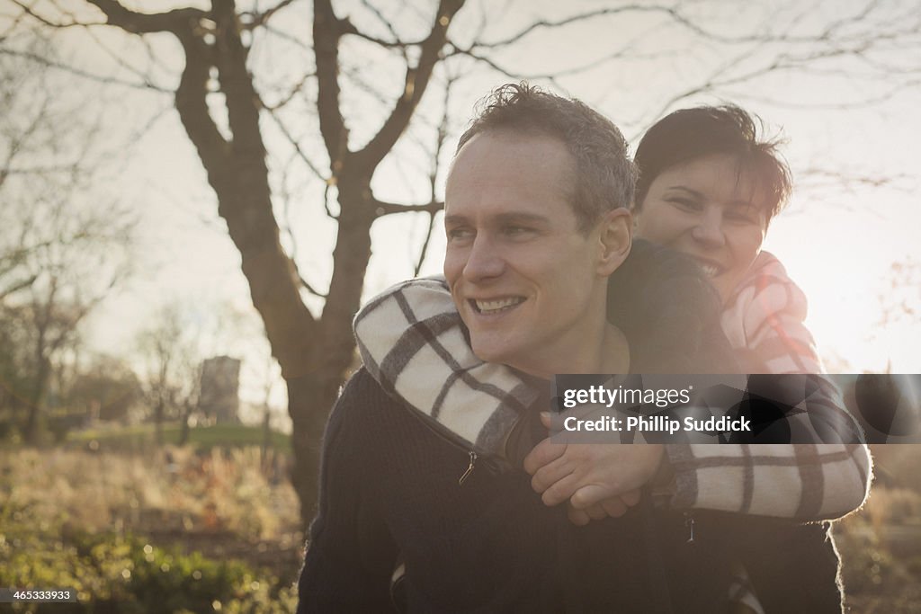 Happy professional couple on piggyback