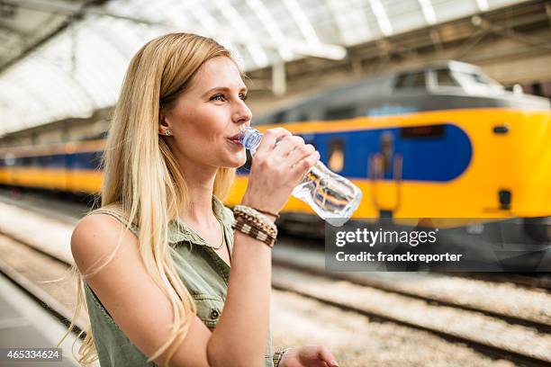 smiling tourist refreshment at the station - water station stock pictures, royalty-free photos & images