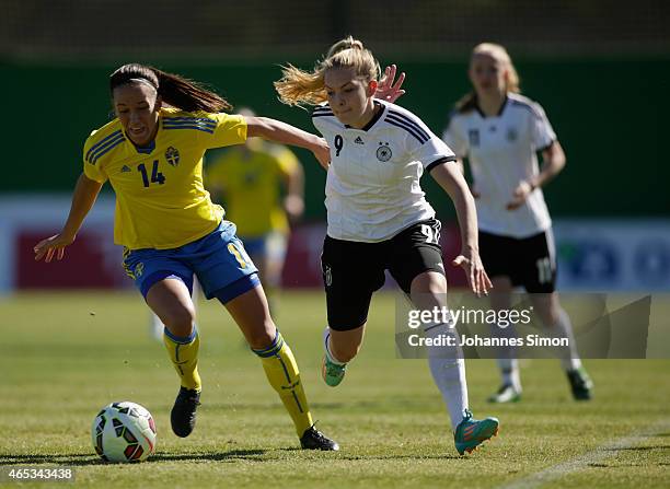 Anna Oskarsson of Sweden and Nina Ehegoetz of Germany fight for the ball during the women's U19 international friendly match between Sweden and...