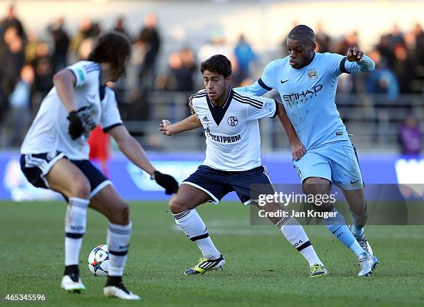 Christian Sivodedov of FC Schalke 04 battles with Oliver Ntcham of Manchester City FC during the UEFA Youth League Round of 16 match between...