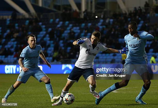 Maurice Multhaup of FC Schalke 04 battles with Tosin Adarabioyo of Manchester City FC during the UEFA Youth League Round of 16 match between...