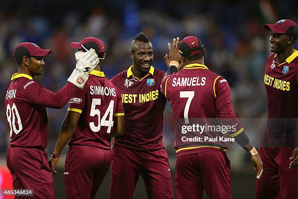 Andre Russell of the West Indies celebrates the wicket of Ravindra Jadeja of India during the 2015 ICC Cricket World Cup match between India and the...